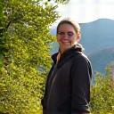 Eliza, 48, vibrant and active, smiling on a hiking trail in Asheville after achieving her fitness goals.