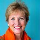 Smiling woman, 'Maria R., Small Business Owner'